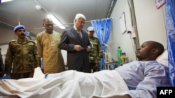 A handout picture released by the United Nations-African Union Mission in Darfur (UNAMID) shows Hervé Ladsous, the United Nations Under-Secretary-General for Peacekeeping Operations, meing in the UNAMID base in Nyala, South Darfur, one of the three injured UNAMID peacekeepers attacked in an ambush near Labado, East Darfur, on July 4, 2013. 