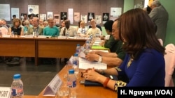 J.J. Johnson, background, tells fellow U.S. and Vietnamese veterans in Ho Chi Minh City why he refused the draft, linking the U.S. civil rights movement of the 1960s to the anti-war protestors like himself.