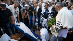 In this May 18, 2021 file photo, mourners attend the funeral of Yigal Yehoshua, 56, at a cemetery in Hadid, central Israel. (AP Photo/Oded Balilty, File)