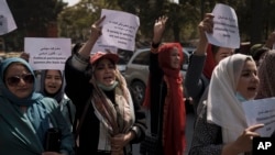 FILE - Women march to demand their rights under the Taliban rule during a demonstration near the former Women's Affairs Ministry building in Kabul, Afghanistan, Sept. 19, 2021.