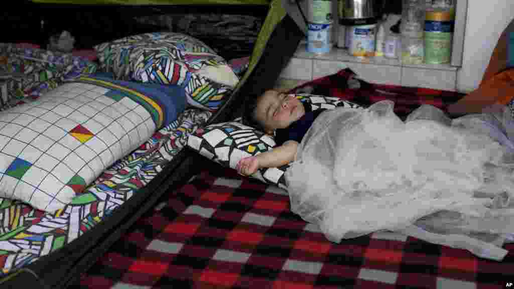 Une petite fille Afghane de 1 an, Yaldof Natzafi, dans une tente, dans un ancien aéroport abandonné qui est utilisé comme refuge par des milliers de migrants, dans le sud d&#39;Athènes, le 20 juin 2016.