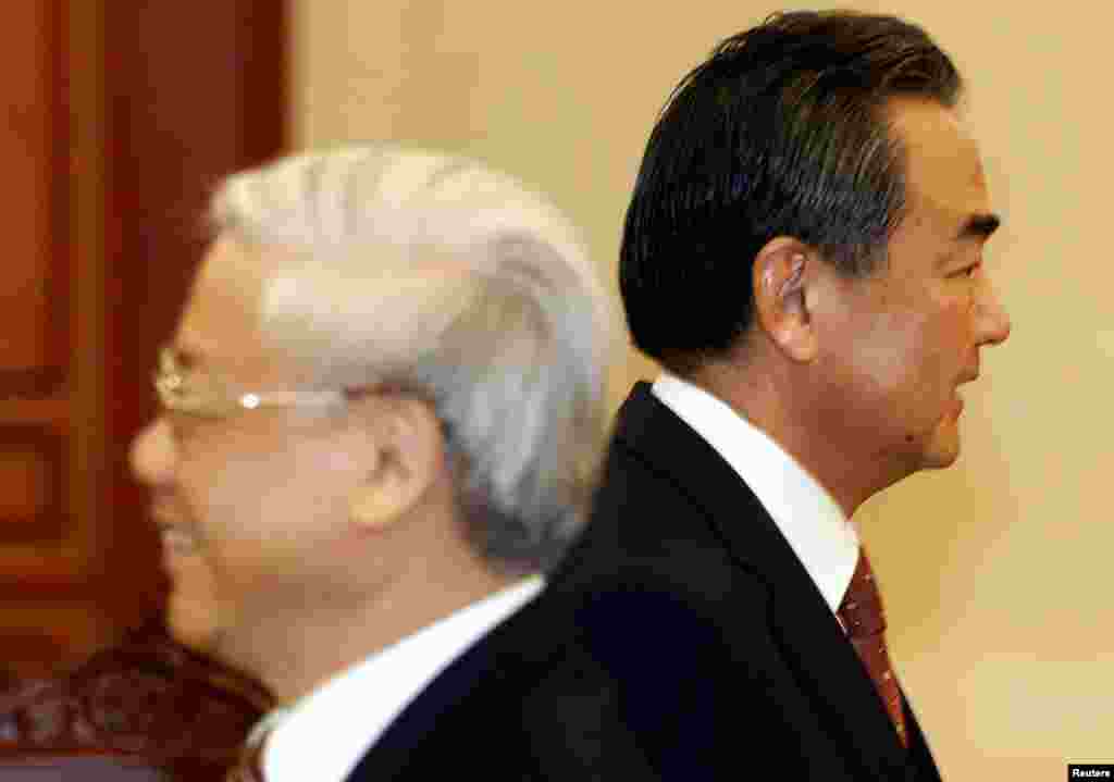 China&#39;s Foreign Minister Wang Yi (R) walks past Vietnam&#39;s Communist Party&#39;s General Secretary Nguyen Phu Trong upon his arrival for the meeting at the party&#39;s head office in Hanoi, Vietnam.