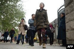 FILE - Chinese middle school students take a break in Beijing.
