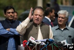 FILE - Pakistani Prime Minister Nawaz Sharif speaks to reporters outside the premises of the Joint Investigation Team, in Islamabad, Pakistan, June 15, 2017.