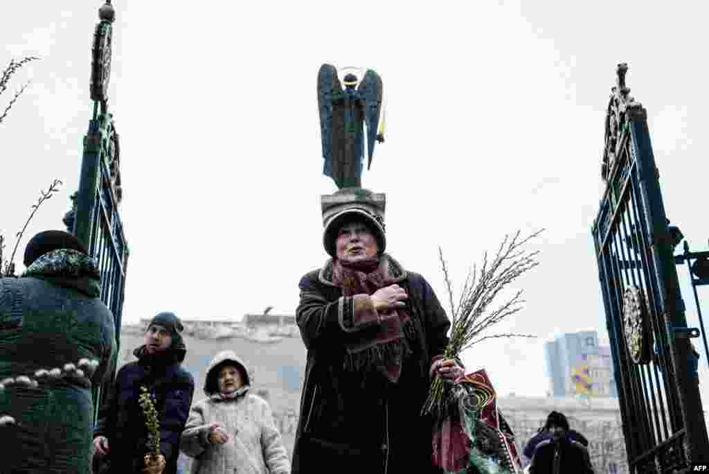 An Orthodox Christian woman crosses herself after the Palm Sunday Mass in the eastern Ukrainian city of Donetsk.