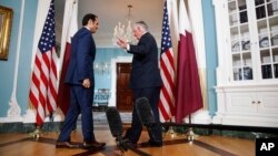 Secretary of State Rex Tillerson waves off questions from the media after shaking hands with ‎Qatari Foreign Minister Sheikh Mohammed bin Abdulrahman Al Thani, June 27, 2017.
