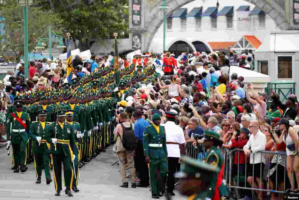 An honor guard marches before the arrival of Britain&#39;s Prince Charles and Camilla, Duchess, of Cornwall on a visit to Barbados.