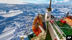 FILE - Russian ship Akademik Shokalskiy is shown trapped in thick Antarctic ice, 1,500 nautical miles south of Hobart, Australia, Friday, Dec. 27, 2013.