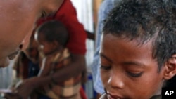 A Somali child refugee receives a vaccine for measles at the United Nations High Commissioner for Refugees (UNHCR) transit center in Dolo Ado near the Ethiopia-Somalia border, August 11, 2011