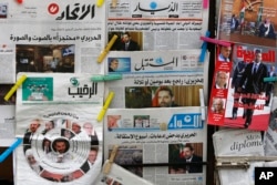 Lebanese newspapers with coverage of an interview with resigned Lebanese Prime Minister Saad Hariri hang at a newstand, in Beirut, Lebanon, Nov. 13, 2017.