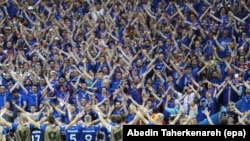 Iceland players celebrate with their fans after the final whistle of the match between Iceland and Austria at Stade de France in Saint-Denis, France, 22 June 2016. Iceland won 2-1. 