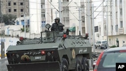 A military armored vehicle in Ettadhamoun, west of Tunis, Jan 12, 2011