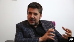 FILE - In this May 26, 2016, photo, Rahmatullah Nabil, a former head of Afghanistan's secret service, speaks during an interview with the Associated Press in Kabul, Afghanistan.