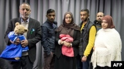The families of missing British girls Amira Abase and Shamima Begum pose for a picture after being interviewed by the media in central London, Feb. 22, 2015. 
