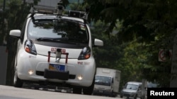 An autonomous self-driving vehicle goes onto the road during a demonstration at one-north business park in Singapore October 12, 2015.