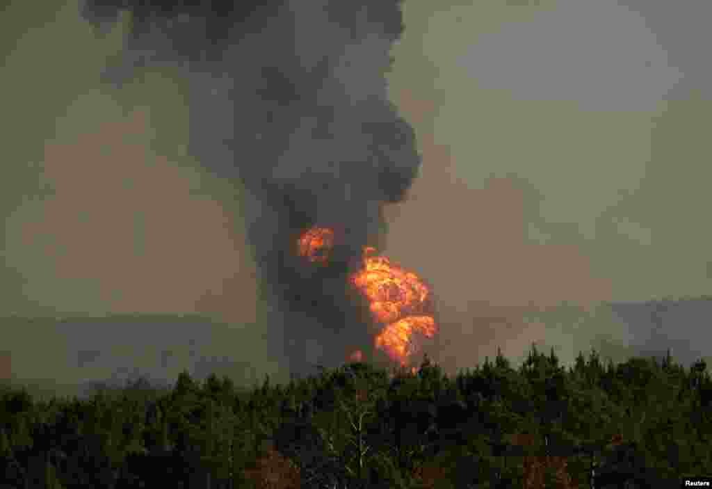 Flames shoot into the sky from a gas-line explosion in western Shelby County, Alabama, Oct. 31, 2016.