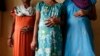 FILE - Surrogate mothers (L-R) Daksha, 37, Renuka, 23, and Rajia, 39, pose for a photograph inside a temporary home for surrogates provided by Akanksha IVF centre in Anand town, about 70 km (44 miles) south of the western Indian city of Ahmedabad.