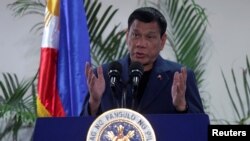 FILE - Philippine President Rodrigo Duterte interacts with reporters during a news conference upon his arrival from a four-day state visit in China.