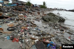 Debris and damaged property is seen after a tsunami, in Sumur, Banten province, Indonesia, Dec. 26, 2018.