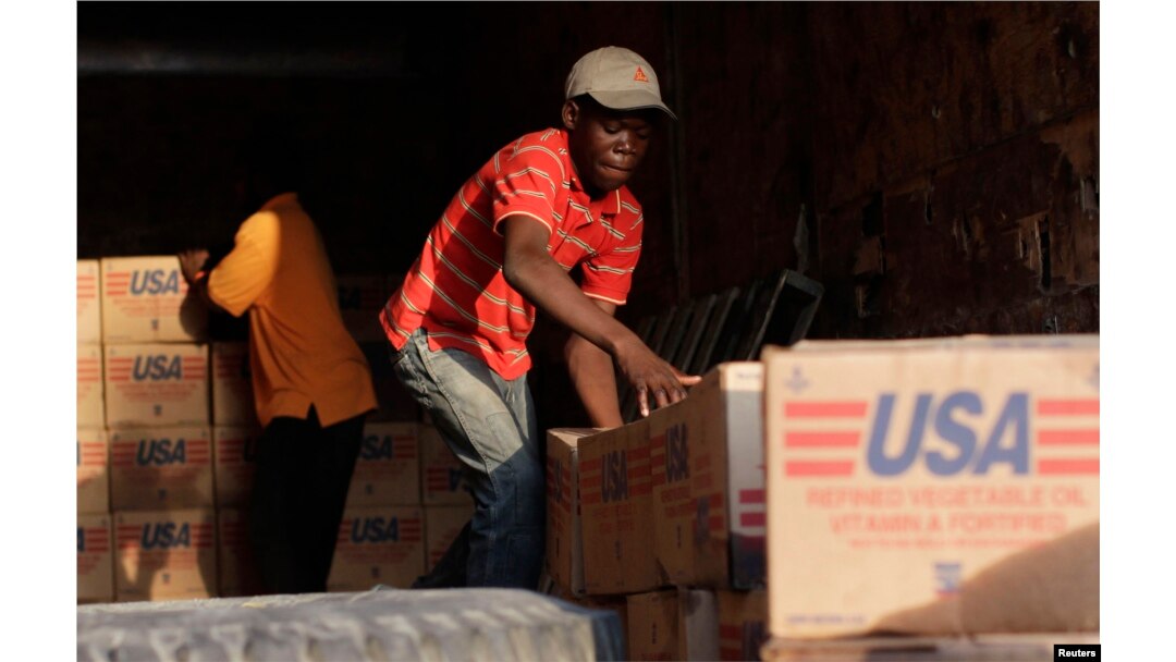 Americans donated more than $1.4 billion to nearby Haiti after a devastating earthquake in January 2010. Here, men stack supplies in Port-au-Prince on March 17, 2010.