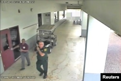 FILE - Then-Broward County Sheriff's Deputy Scot Peterson, who was assigned to Marjory Stoneman Douglas High School during the Feb. 14, 2018 shooting, is seen in this still image captured from the school surveillance video released by Broward County Sheriff's Office in Florida, March 15, 2018.