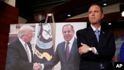 Rep. Adam Schiff, D-Calif., ranking member of the House Intelligence Committee stands next to a photograph of President Donald Trump and Russian Foreign Minister Sergey Lavrov, during a news conference on Capitol Hill in Washington, May 17, 2017.
