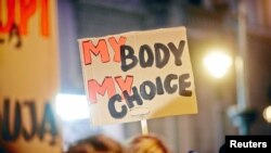 People gather to protest against plans to further restrict abortion laws, in Lodz, Poland, March 23, 2018.