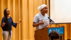 De'Ivyion Drew, UNC-Chapel Hill student and community activist, right, speaks as Taliajah "Teddy" Vann, president of the campus Black Student Movement, agrees with her message, during a press event held by the Black Student Movement, the Carolina Black Caucus and the Black Graduate and Professional Student Association on Wednesday, July 7, 2021, at UNC Chapel Hill's Sonja Haynes Center in Chapel Hill, N.C. (Travis Long/The News & Observer via AP)