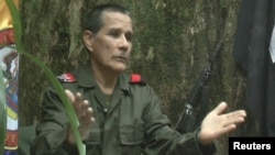 FILE - National Liberation Army (ELN) commander Nicolas Rodriguez, known as "Gabino," gestures as he speaks in response to questions from Reuters at a hidden jungle camp in this still image taken from an undated video released August 27, 2012.