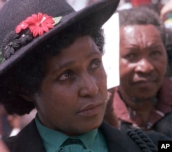 FILE -- In this March 5, 1986 file photo, Winnie Mandela mourns the death of 17 black activists at a funeral service held in Johannesburg, South Africa.