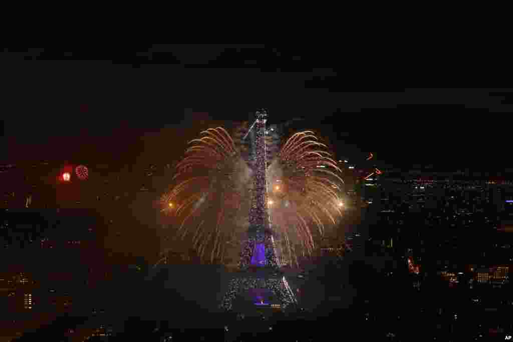 A view of the fireworks display by the Eiffel tower on Bastille Day, in Paris, France.