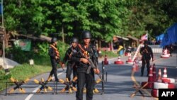 FILE -Thai Rangers at a checkpoint in the Cha nea district in Thailand's restive southern province of Narathiwat, April 27, 2017.