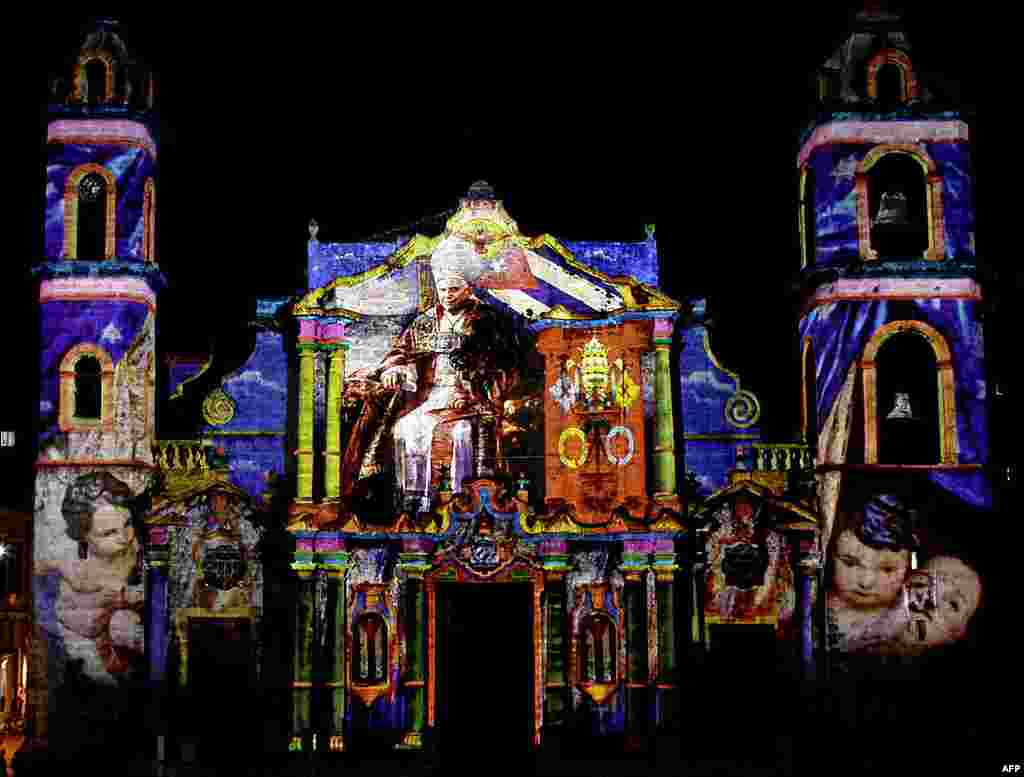 Images of Pope Benedict by the French-Italian artist Gaspare Di Caro are projected on the facade of Havana's cathedral in Havana, Cuba, March 25, 2012. (AP)