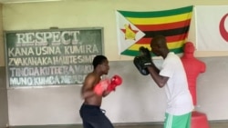 Anthony Possible Mapako, 24, left, trains at the Mosquito Boxing School of Excellence with founder and coach Zvenyika Arifonso in Harare on Nov. 21, 2021. (Columbus Mavhunga/VOA)