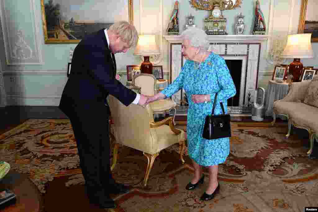Queen Elizabeth II welcomes Boris Johnson during an audience in Buckingham Palace, before officially recognizing him as the new Prime Minister, in London, Britain.