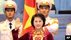 Nguyen Thi Kim Ngan takes the oath of office after being elected as chairwoman of the National Assembly in Hanoi, Vietnam Thursday, March 31, 2016. 