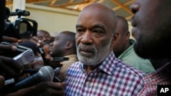 FILE - Haiti's President Rene Preval, center, speaks to the press after casting his vote for presidential elections at a polling station in Port-au-Prince.