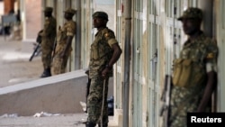 FILE - Ugandan soldiers stand along a street in Kampala, Uganda, Feb. 20, 2016. Ugandan President Yoweri Museveni extended his 30-year rule earlier this year by winning an election critics say lacked transparency and his main opponent Kizza Besiyge denoun