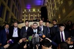 Mohammed Alloush, head of a Syrian opposition delegation, center, speaks to the media after the talks on Syrian peace in Astana, Kazakhstan, Jan. 24, 2017.