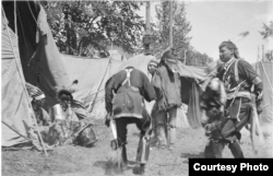 This photo by an unknown photographer shows a group of Ho-Chunk, or Winnebago, Indians at pow wow in Wisconsin, 1907. National Anthropological Archives, Smithsonian Institute. BAE GN 4413