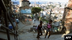 Locals walk in the Morro Da Providencia shantytown in Rio de Janeiro, Aug. 17, 2012. Hundreds of families were evicted from Rio favelas because of preparation work needed for the 2014 FIFA World Cup and the 2016 Olympic Games.