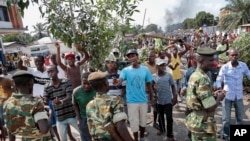 Des manifestants, branches d'arbres en main,font face aux soldats dans le district de Mutarakura, près de Bujumbura, Burundi, mai 2015.