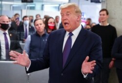 U.S. President Donald Trump greets staff members while his son in-law and senior advisor Jared Kushner looks on as he visits his presidential campaign headquarters on Election Day in nearby Arlington, Virginia, U.S., November 3, 2020.