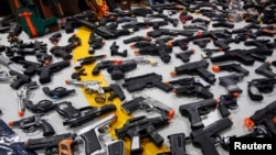 FILE - A collections of toy guns is displayed in a March 4, 2015, photo.