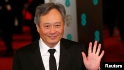 Director Ang Lee poses as he arrives for the British Academy of Film and Arts awards ceremony at the Royal Opera House in London, Feb. 10, 2013.