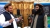 On Feb. 2, 2013, Tehreek-e-Taliban spokesman Ehsanullah Ehsan, left, talks with a new TTP member following a press conference in Shabtoi, a village in Pakistan. 