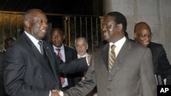 Laurent Gbagbo, left, shakes hands with Kenyan Prime Minister Raila Odinga, an African Union envoy sent to mediate the ongoing Ivorian political standoff, at the presidential palace in Abidjan, Ivory Coast, 17 Jan 2011