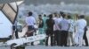 Chinese activists detained after landing on a disputed island are escorted by airport officials as they board a flight to Hong Kong, in this photo taken by Kyodo August 17, 2012. 