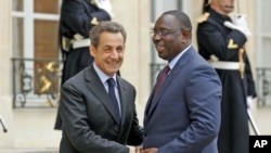 France's President Nicolas Sarkozy (L) greets Senegal's newly-elected President Macky Sall at the Elysee Palace in Paris, April 18, 2012.