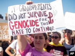 Danielle Nanni holds up a sign while listening to speakers during a rally against hate in Berkeley, California, Sunday, Aug. 27, 2017.